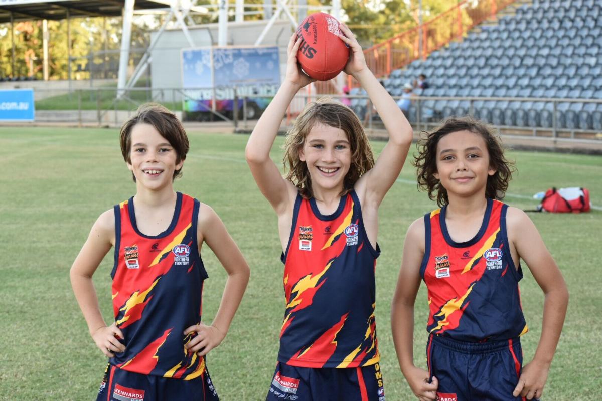 Thunder Juniors girls pose in their new Crows uniform