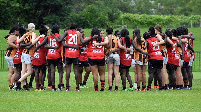 Big River Hawks and Tiwi Bombers players come together